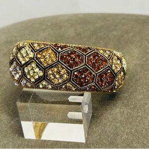 Cuff bracelet with a honeycomb pattern and amber-colored rhinestones